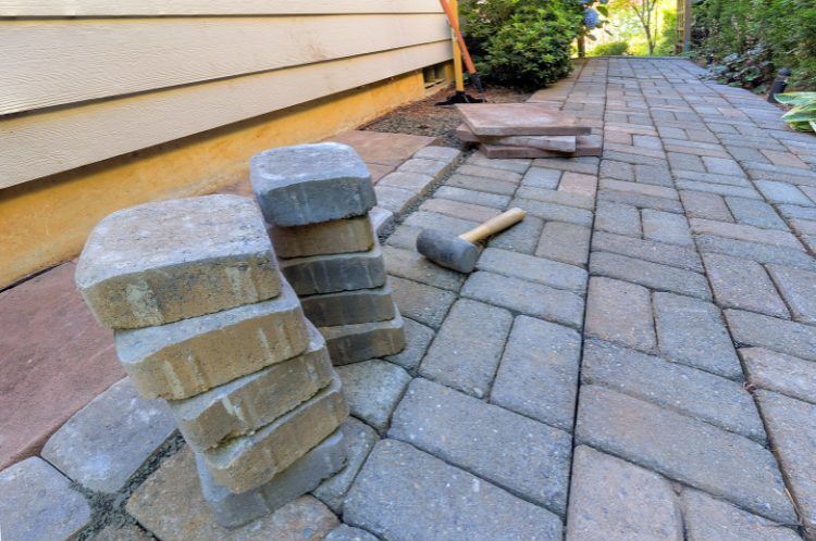 backyard hardscaping - backyard brick path being laid