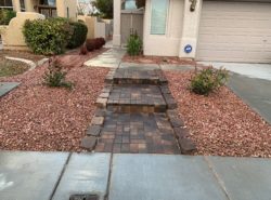 brick paver walkway bordered by rocks